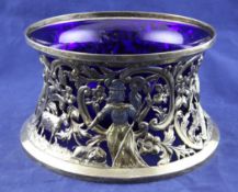 A George V Irish pierced silver potato ring with blue glass liner, decorated with animals and