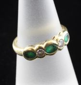 An 18ct gold five stone emerald and diamond half hoop ring, size L.