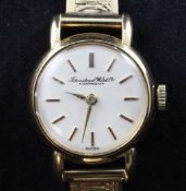 A lady`s 18ct gold International Watch Co. manual wind wrist watch, with baton numerals, on an