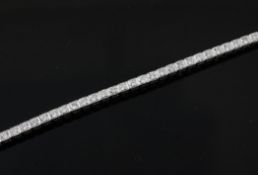 An 18ct white gold and diamond line bracelet, set with forty six round brilliant cut stones with a