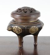 A Chinese parcel gilt bronze tripod censer and wood cover, 18th/19th century, the lobed globular