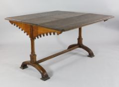 A Victorian gothic revival drop leaf dining table, with gothic arch hinged bearers, on square
