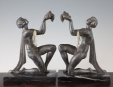 A pair of French Art Deco spelter and silvered bronze figures of kneeling maidens, on rectangular