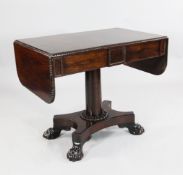 A Regency rosewood sofa table, with gadrooned border, cylindrical column and platform base with lion