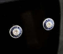 A pair of white gold, sapphire and diamond set target earrings.