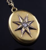 A late Victorian gold, diamond and enamel oval locket, with star burst motif (enamel worn), on a
