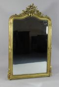 A Victorian giltwood overmantel mirror, the arch top with pierced floral crest with bevelled
