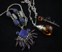 A silver mounted amber pendant necklace, and two other items.