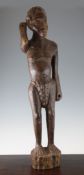 An African carved hardwood figure of a standing male warrior, probably once holding a spear, on