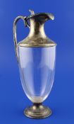 A late Victorian silver mounted glass claret jug, of vase form, with beaded borders and handle,