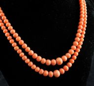 A double strand graduated coral bead necklace with 14ct gold engraved box tongue clasp, with two