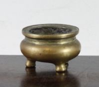 A small Chinese bronze tripod censer, Xuande four character seal mark, 18th/19th century, 5.5cm.,