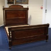 A French brass mounted and mahogany double bed frame, with fluted pillars and arched crest,