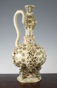 A Hungarian pottery Persian style ewer, by Fischer, late 19th century, the lobed body with flower
