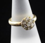 A late Victorian gold and rose cut diamond flowerhead ring, set with seven stones, size N.