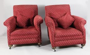 A pair of deep seated armchairs, the scroll backs with red patterned moquette upholstery, on bun