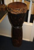 An African double conical tapering drum, with calf skin head and all over geometric carved