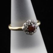 A late Victorian 18ct gold, hessonite garnet and diamond cluster ring, of flowerhead design, size