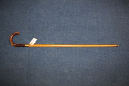 An unusual Brigg gadget walking cane, the leather handle with concealed pencil and the malacca shaft