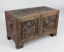 A Chinese carved camphorwood chest, of two short and two long drawers enclosed by a pair of cupboard