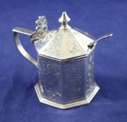 A Victorian silver octagonal mustard pot, with turned finial, pierced thumbpiece and engraved with