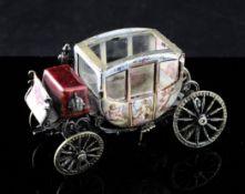 A 19th century Viennese silver gilt and enamel miniature carriage, with red guilloche enamel seat