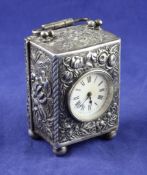 A late Victorian repousse silver cased miniature carriage timepiece, with Roman dial and French