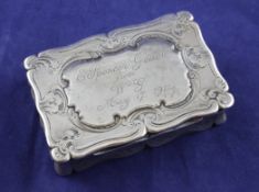 An early Victorian silver snuff box, of shaped rectangular form, with engraved foliate scroll