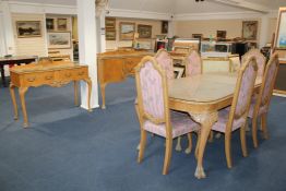 An 18th century style bleached burr walnut nine piece dining room suite, the table, six arched