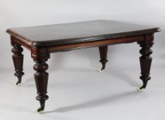 A Victorian mahogany extending dining table, with four extra leaves, on turned and part fluted