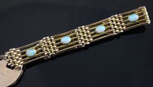 An Edwardian 9ct gold and white opal gate link bracelet, with padlock shaped clasp and set with
