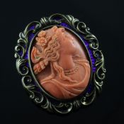 A Victorian gold, coral and blue enamel cameo brooch, of oval form, carved with the bust of a lady