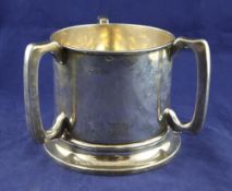 An Edwardian large silver tyg, of cylindrical form, on spreading foot, Barker Brothers, Chester,