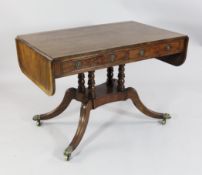 An early 19th century mahogany sofa table, with two frieze drawers opposing two dummy drawers,
