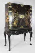 A late 17th century chinoiserie lacquer cabinet, with two doors enclosing ten drawers with