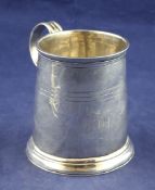 A Queen Anne silver mug, of tapering cylindrical form, with reeded band and later? engraved