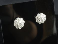 A pair of 18ct white gold and diamond cluster earrings, of flowerhead design, with an approximate