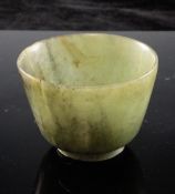 A Chinese green jade cup, possibly Ming Dynasty, the stone with white and black inclusions, 5.5cm.