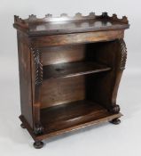 A Regency rosewood open bookcase, with shaped three quarter gallery, stiff leaf carved scrolling