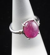 A white gold, cabochon ruby and diamond ring, size K.