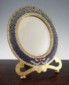 A Venetian oval floral micro mosaic gilt framed easel mirror, decorated with a pink and white bow