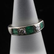 An 18ct white gold five stone emerald and diamond half hoop ring, size L.