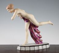 A Royal Dux Art Deco figure of a semi-nude lady, early 20th century, clasping a polychrome gown,
