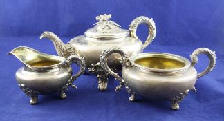 A William IV silver three piece tea set, of cauldron shape, with acanthus leaf handles and spout and