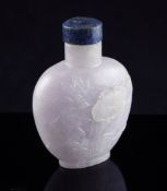 A Chinese pale lavender jadeite snuff bottle, late 19th/early 20th century, carved in relief with