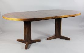 A Gordon Russell `Marwood` rosewood extending dining table, with two extra leaves, with label and