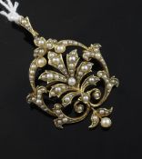 A late Victorian 15ct gold and split pearl set drop pendant brooch, of scrolling openwork design,