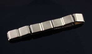 A 9ct gold flat box link bracelet, with radial engraving, bears the inscription "Rolex" with crown