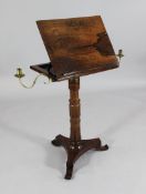 A William IV rosewood reading stand, with adjustable hinged book rest and a pair of brass candle