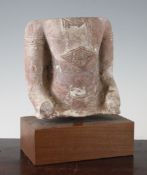 A red sandstone torso of Buddha, possibly Lopburi, Thailand, 13th century, the figure wearing